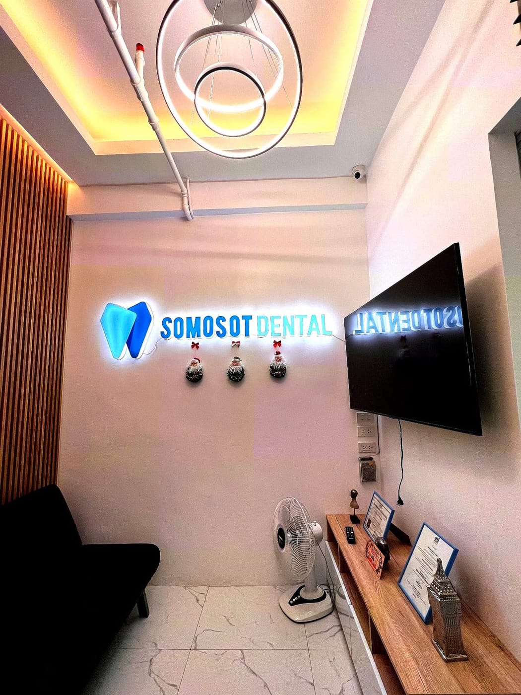 Reception area at Somosot Dental Cebu, with the branch's illuminated Somosot Dental sign
